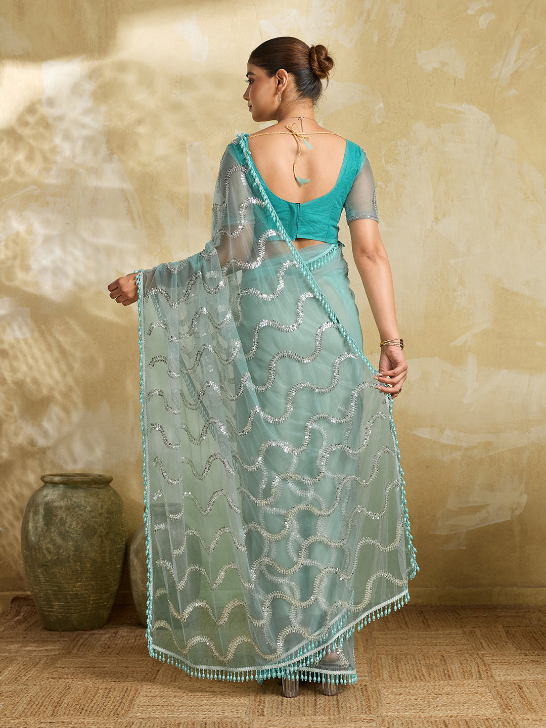 Sea Green Net Saree with Silver Sequin Wave Embroidery and Tasseled Border