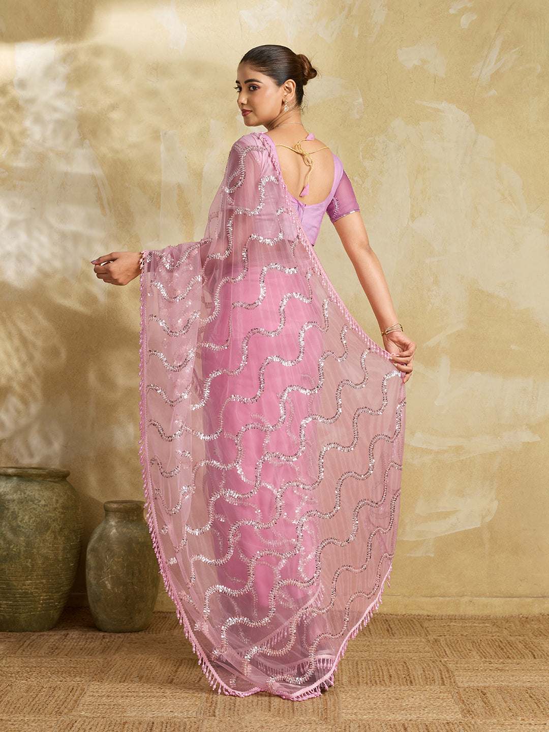 Pink Net Saree with Silver Sequin Wave Embroidery and Tasseled Border